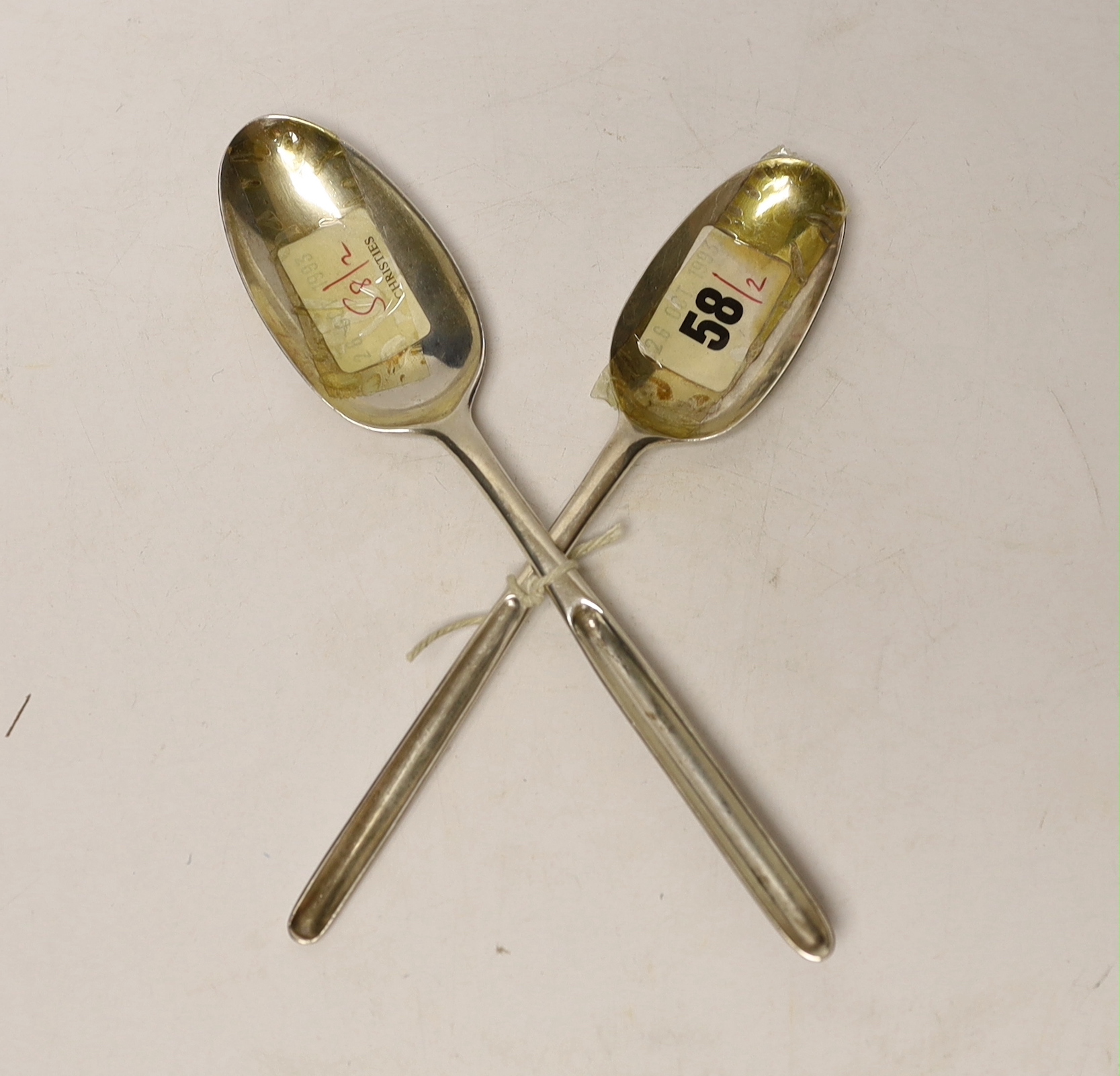 Two 18th century silver combination marrow scoop spoons, smallest with lace back bowl, Marmaduke Daintrey, London, 1741, the other later by Ebeneezer Coker, 21.5cm, 99 grams.